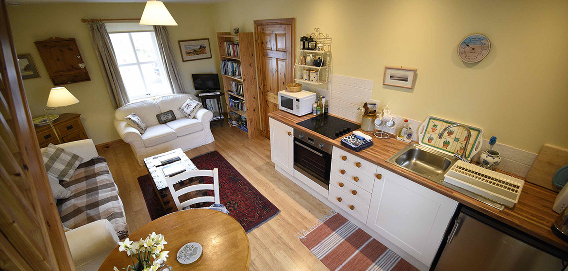 Half of Three self catering accommodation contains an open plan living room with comfortable seating and attached kitchen