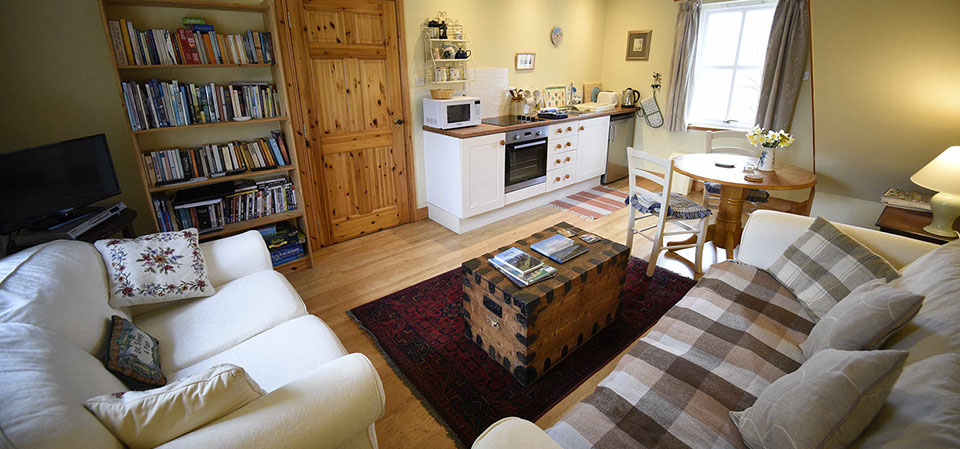 Contact Half of Three self catering accommodation with comfortable seating area and modern kitchen